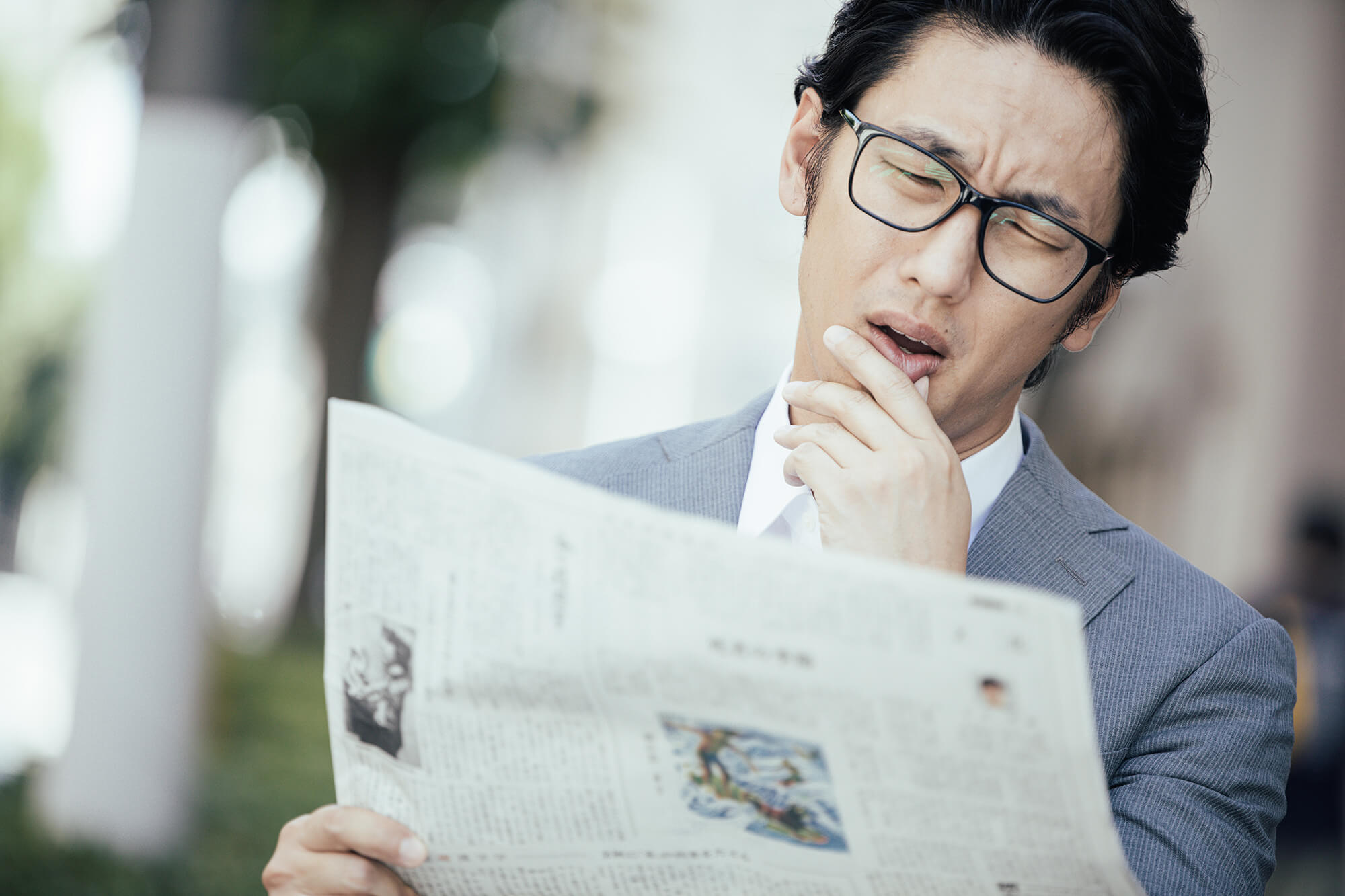 新聞を見て嘆くビジネスマン